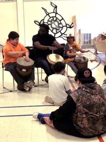 Boat building school students at Pictou Landing First Nation get some drumming instruction