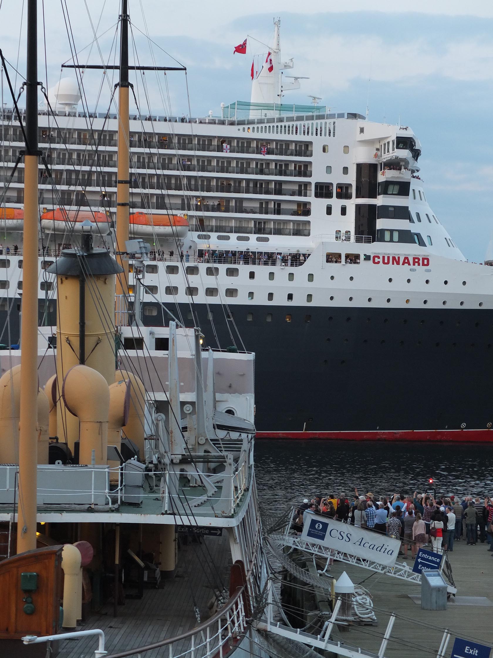 The past meets the present as the Cunard Line's Queen Mary sails past the CSS Acadia